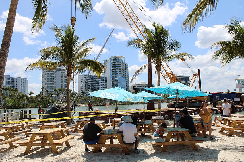 Patrons of O'Leary's Tiki Bar & Grill coincidentally got front-row seats to bid farewell to a wrecked boat brought on by last year's hurricanes.