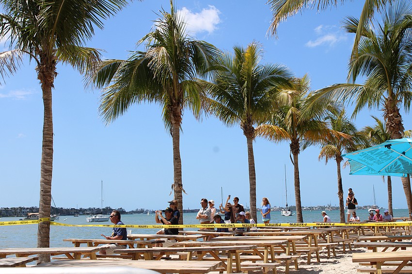 Onlookers lined the beach to watch the boat removal.