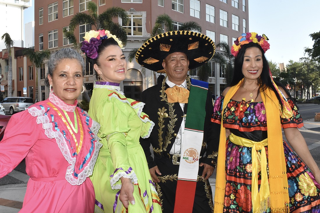 Sarasota friends Veronica Muñoz, Maria Veronica Guillen Vasquez and Benito Enriquez, who are from Mexico, and Maria Stephens, who is from Venezuela, dressed up to represent their home countries. "I love Mexicans and I think they're my brothers and my sisters," Stephens said.