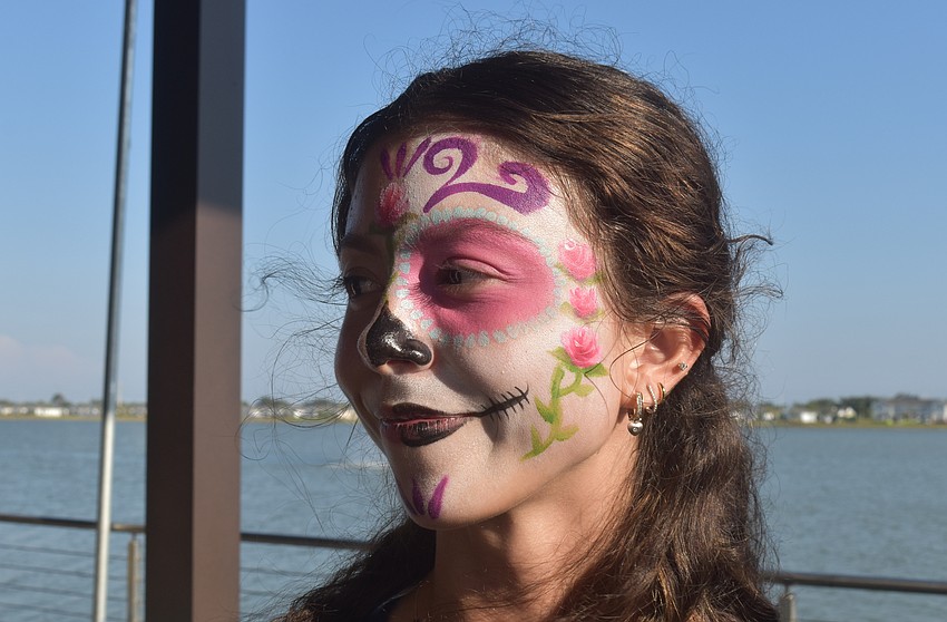 Zhanna Canner has worked as a waitress at Agave Bandido for almost a year and gets into the holiday spirit with face paint.