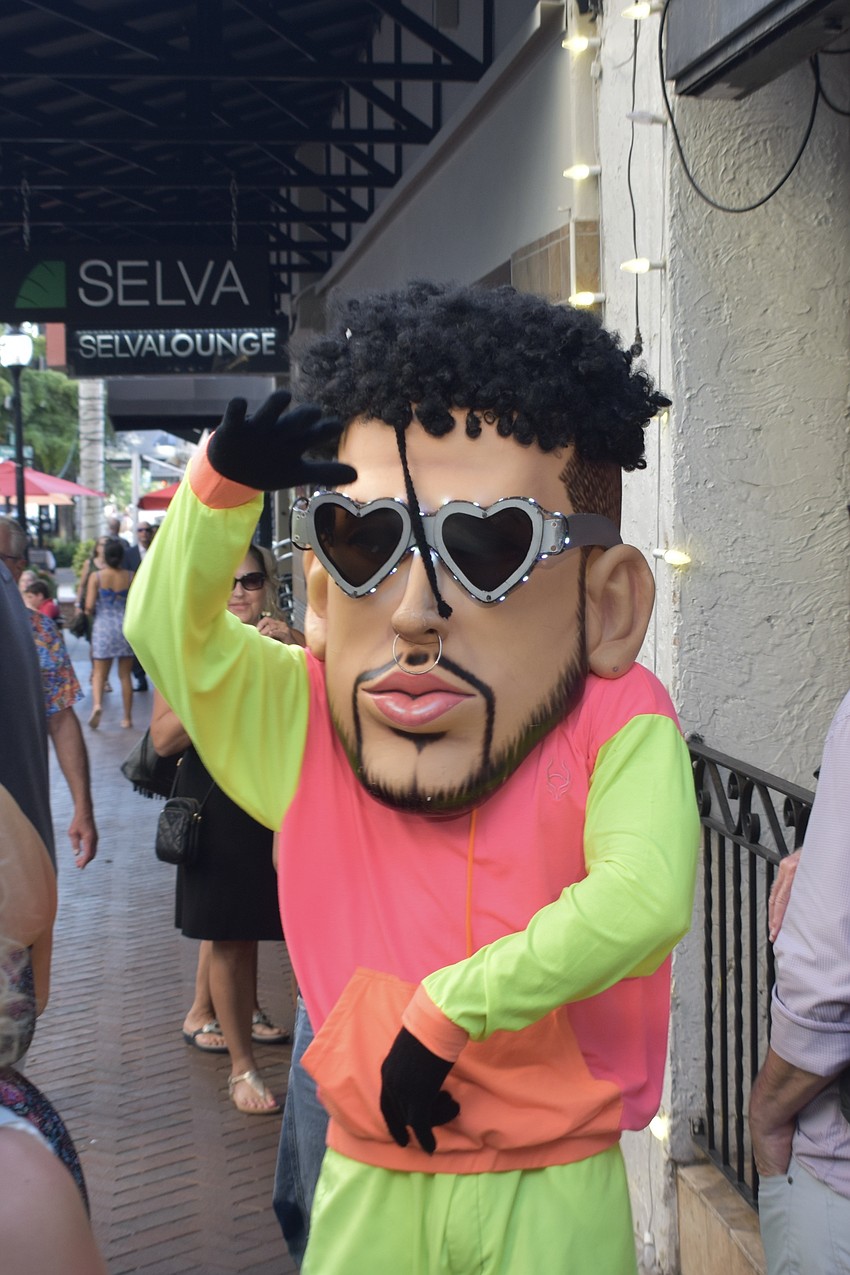 A costumed performer enters the scene.