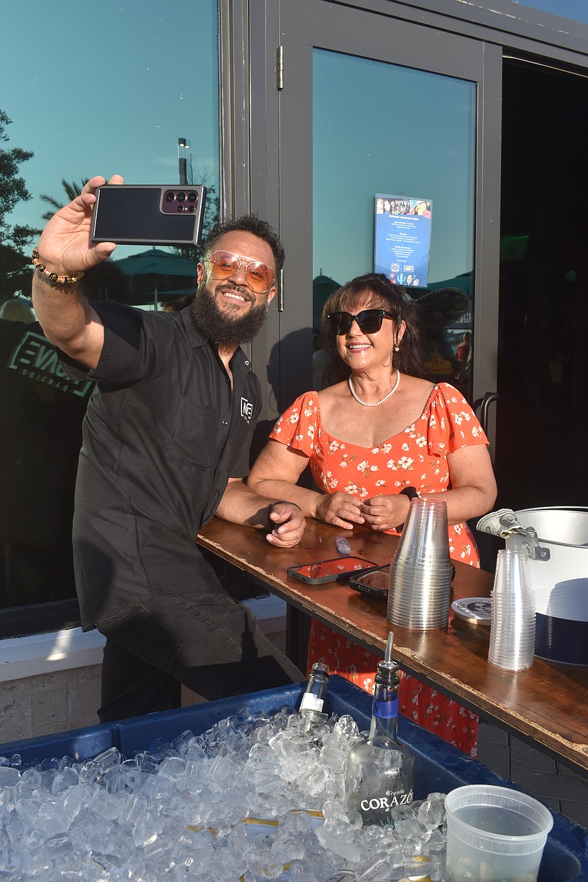 Lakewood Ranch resident Mark Sulca poses with his mother Divina Brian of Sarasota in between his bartending duties during the Cinco de Mayo party at Agave Bandido.