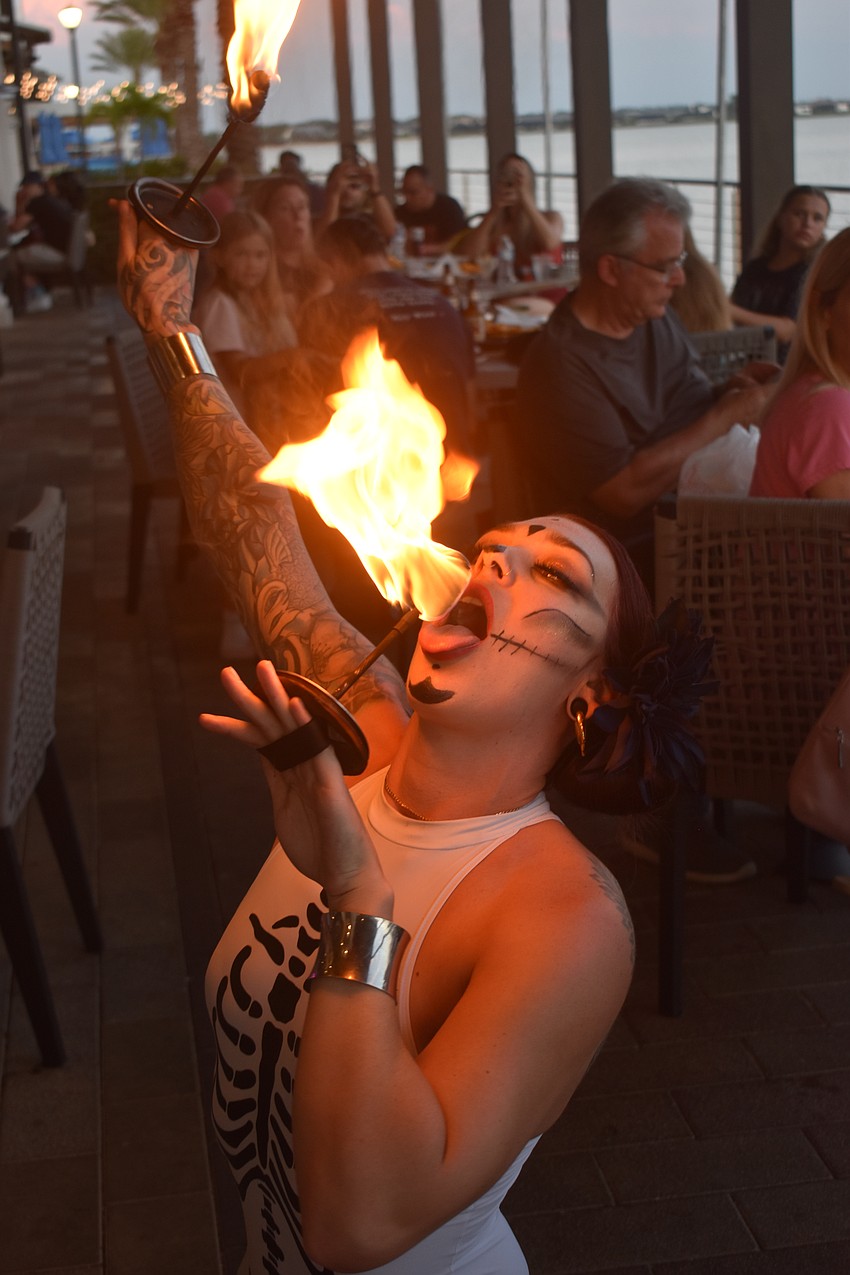 Tampa resident Alannis Peterson of Prism Artistry eats fire at Agave Bandido in Lakewood Ranch during the Cinco de Mayo celebration.