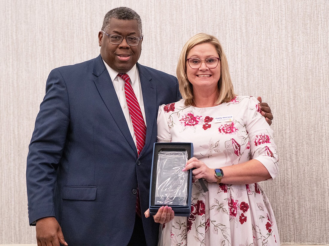 Octavius Holliday, an assistant state attorney and special prosecution director in the 4th Judicial Circuit, is the Jacksonville Daily Record 2025 Lawyer of the Year on May 1. At right is Daily Record Publisher Angie Campbell, who presented the award.