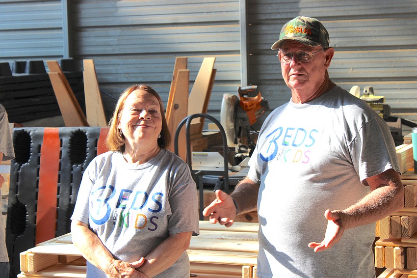 Brenda Coates and her husband, Mark, who is the founder of Beds for Kids, greet the Keller Williams Coastal Living II employees who came to volunteer May 8.