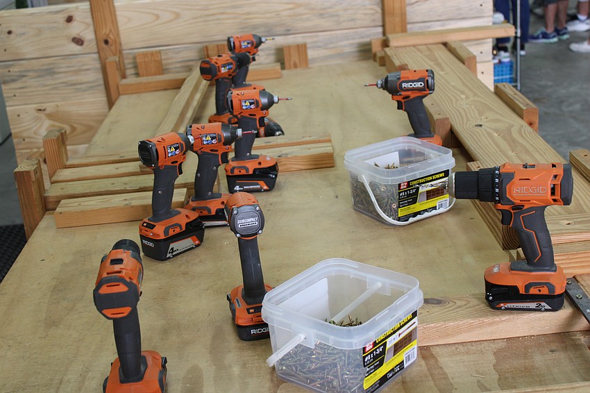The tools are set out at the workshop of East County's Mark Coates, waiting for the volunteers on Keller Williams' annual Red Day to give back to their community.