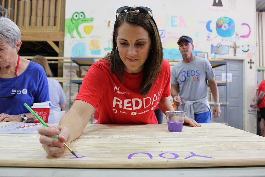 Realtor Elyssa Hackett uses her artistic talent during her first Keller Williams Red Day event.