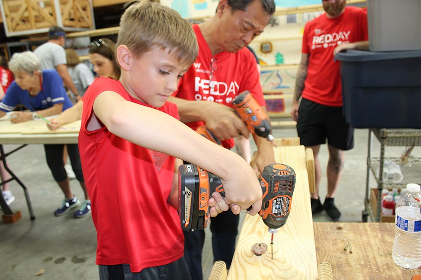 Rory Jones, 9, volunteered during Red Day as his mom, Paula Jones, is head of the Keller Williams' Culture Committee.