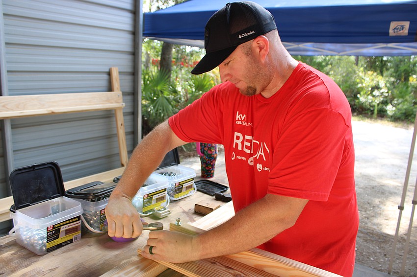 Steve Hackett, whose wife Elyssa is a Realtor for Keller Williams, was handling some of the more complicated hardware tasks. Hackett, who owns a handyman service, says, 