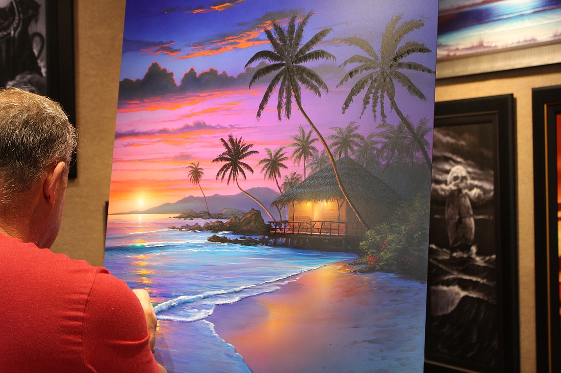 Artist Stephen Muldoon paints live at Wyland Gallery Sarasota on St. Armands Circle.