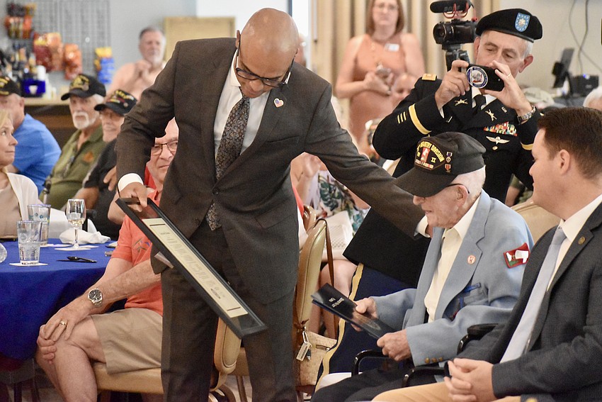 Edward Baldez, Veterans and Military liaison for Congressman Vern Buchanan, presents Platoon Sgt. John Skeen with a proclamation from the congressman.