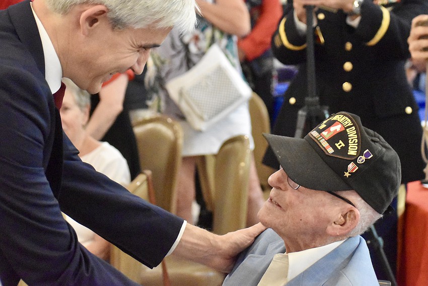 France's Consul General Raphael Trapp thanks Platoon Sgt. John Skeen for his service and presents him with the Knight of Legion Honor Award.