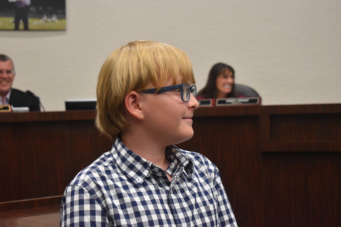 Mark Eubanks IV reads his essay “Chess with My Grandma” at the school board meeting April 29.