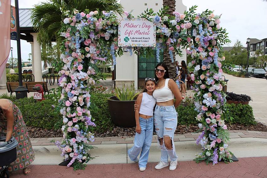 Samantha Baeza, 9, and her mom, Loriana Soria, begin checking out the Mother's Day event at Waterside Place May 10.