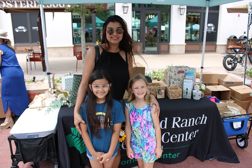 Cynthia Gohil of Lakewood Ranch takes her 7-year-old daughter, Sanah, and her friend 6-year-old Illyana Recher to the Lakewood Ranch Medical Center booth during the special Mother's Day event at Waterside Place May 10.