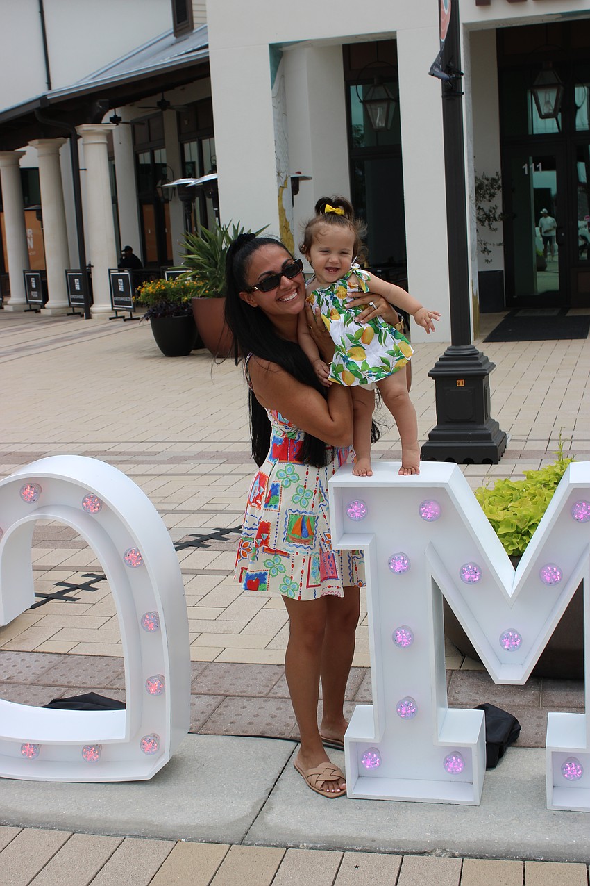 The letters that spelled out Mom at Waterside Place during the special event May 10 also became a play area for mom Michele Mittiga and 11-month-old Vanessa.