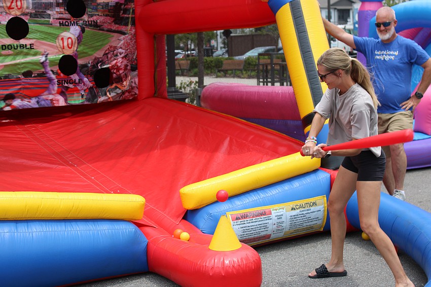 Some moms like to test their hitting skills as Christina Wichmer did during the Mother's Day event May 10 in Waterside Place.