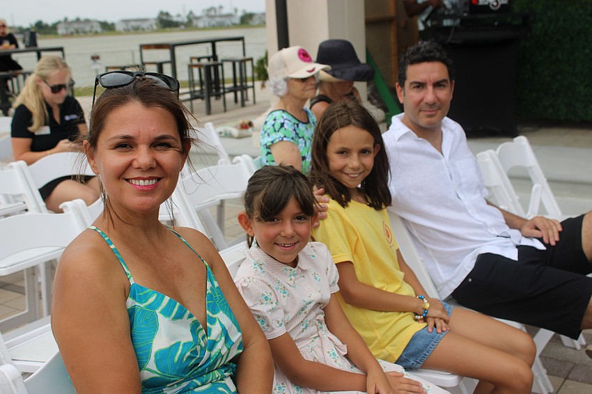 Marsida Mania, and Grace, Chloe, and Jetmir Salihi get great seats for the Petals and Poses fashion show at Waterside Place May 10.