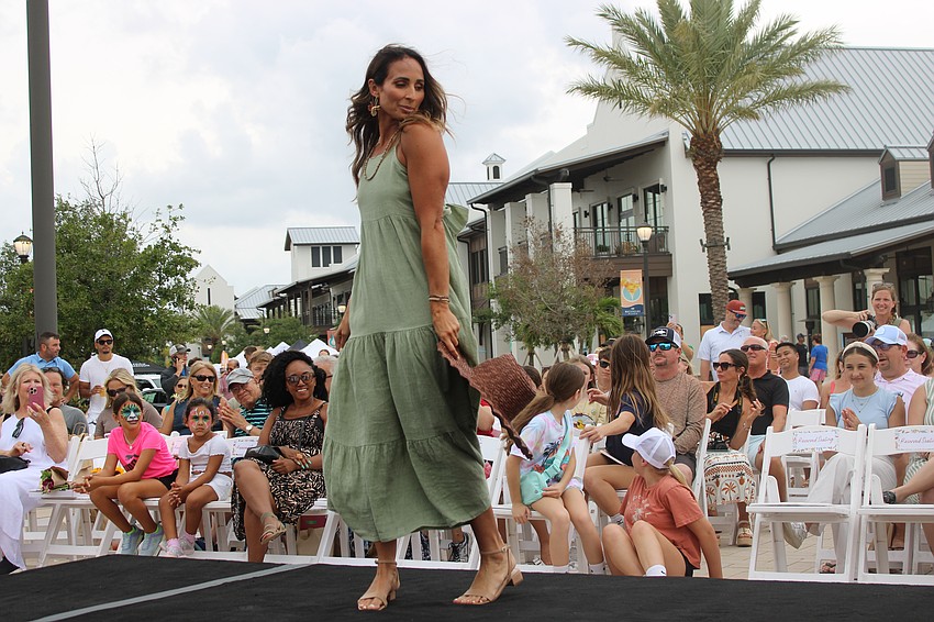Nicole Houser shows a little attitude as she makes the turn at the end of the runway during the Petals and Poses fashion show May 10 at Waterside Place.