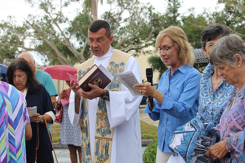 Father Robert Dzieddiak and Sandy Montrone lead the hymns and Marian prayer at the May Crowning Ceremony at St. Mary, Star of the Sea, Catholic Church.