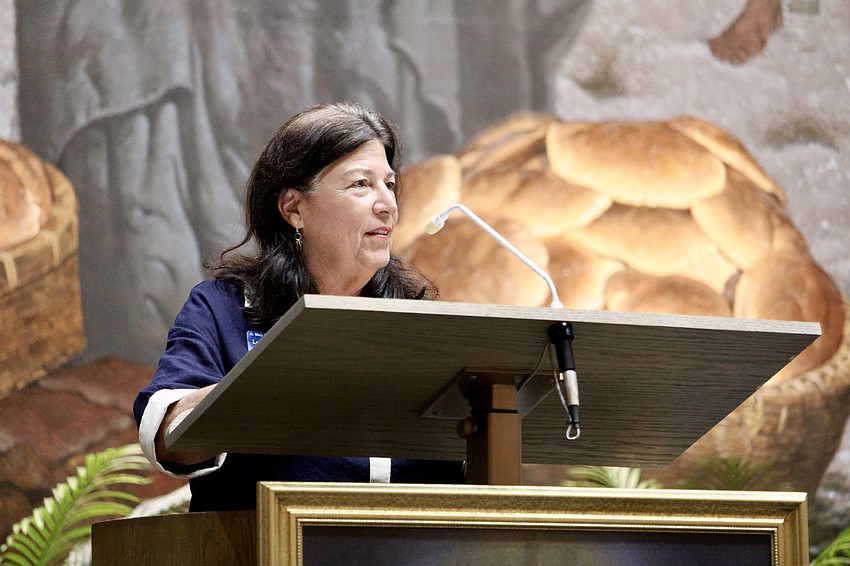Lyn Kennelly, vice president of the St. Mary, Star of the Sea, Catholic Church Women's Guild, welcomes attendees to the special Sunday service and introduces honoree Paula Sharp. Kennelly said the church reveres Mary all year but that May is an exceptional time for celebration.