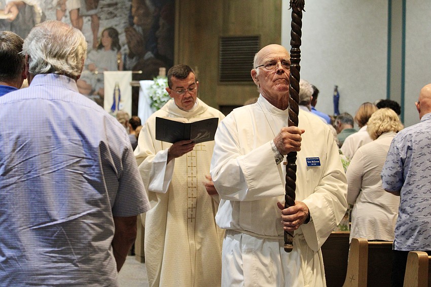 Terry McGovern and Robert Dziediak lead the procession out of St. Mary, Star of the Sea, Catholic Church after the Sunday service.