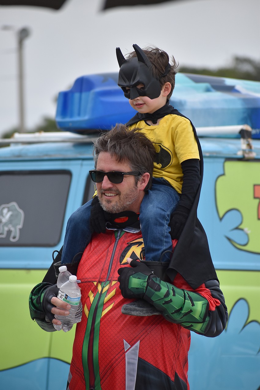 Patrick Alexander and his son Henry Alexander, 4, watch the swordplay demonstration.