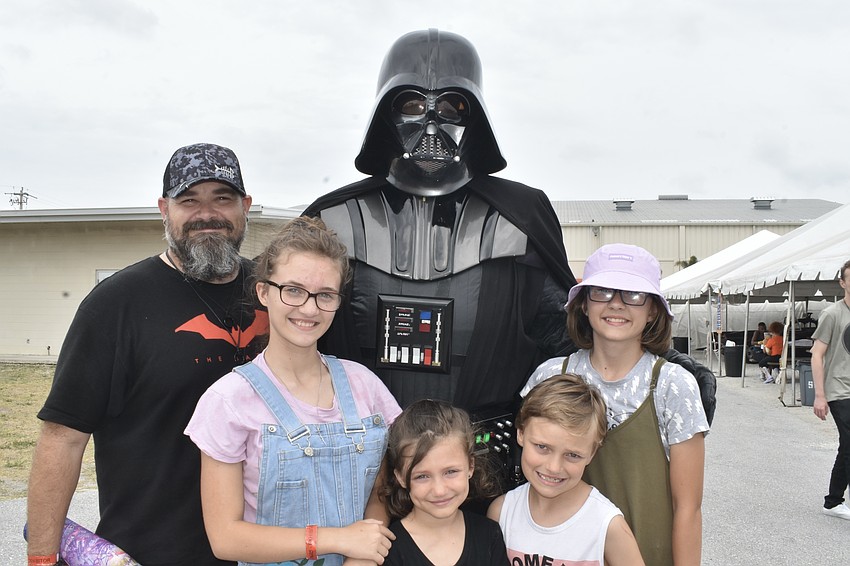 Beau Bailey and his children Annie Bailey, 13, Kaley Bailey, 6, James Bailey, 8 and Abby Bailey, 11, meet Bryan Shuerger of the 501st Legion's Tampa Bay Squad, dressed as Darth Vader.