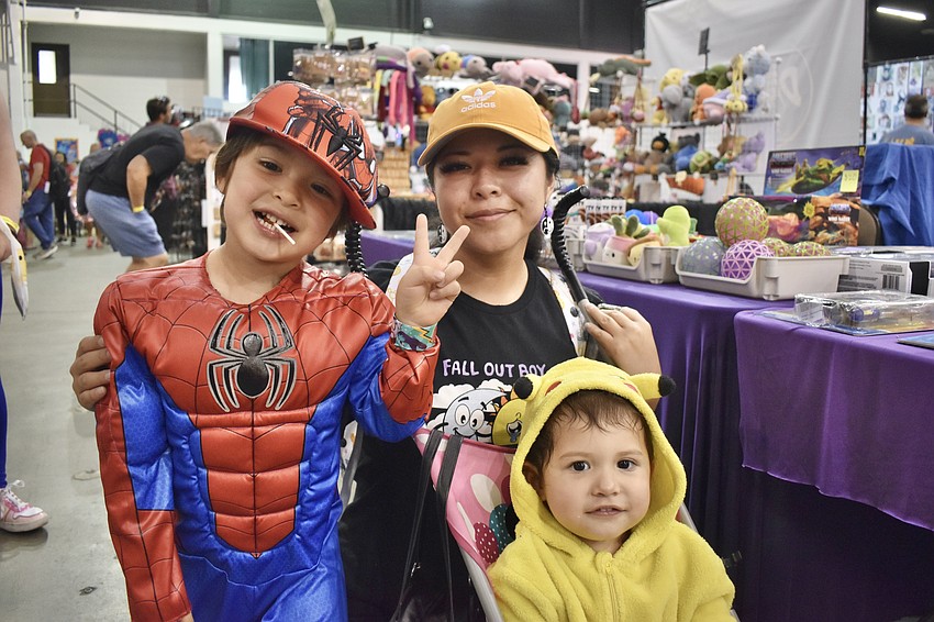 Dean Pope, 4, his mom Betsy Pope, and sister Yuri Pope, 2, enjoy the festive atmosphere.