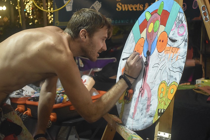 Sam North, an artist known as Sammy thrashLife, works on a painting.