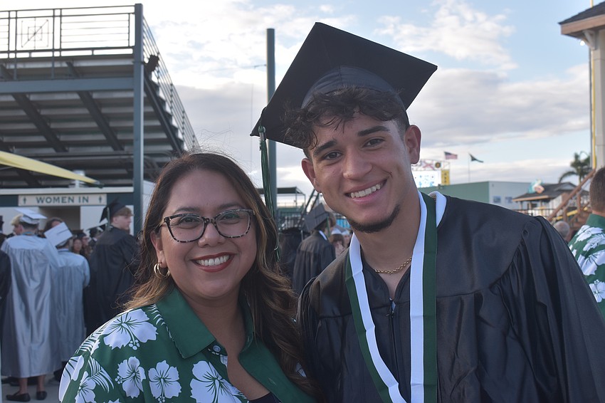 Avelina Besse, a teacher's aide at LRHS, and Victor Hugo Madalena pose together before the commencement ceremony. Madalena can speak Portugese, English, Italian and Spanish.