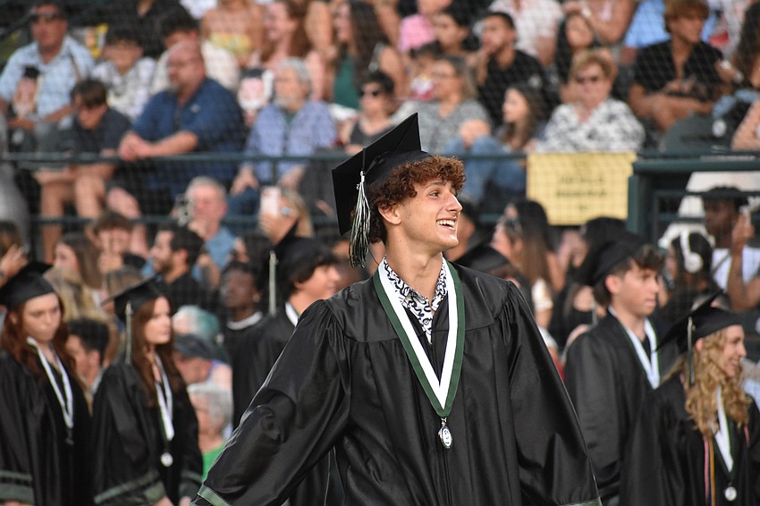 Wayne Boatwright scans the crowd before dancing his way to receive his diploma.