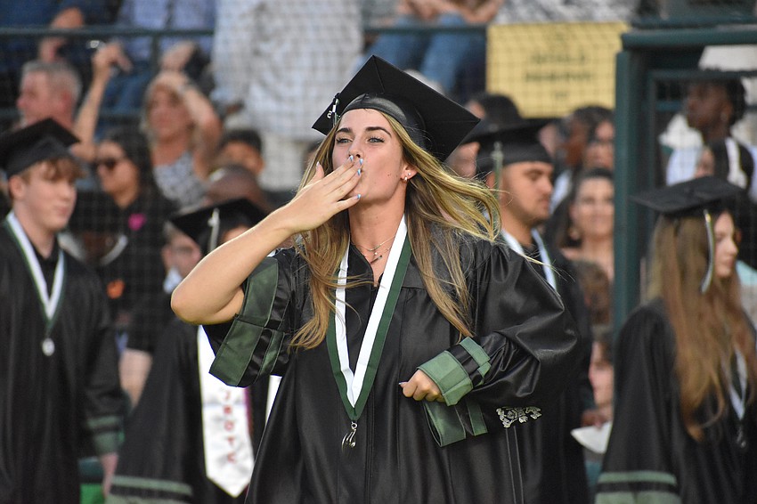 Daytona Clifton blows kisses and dances as she heads to receive her diploma.