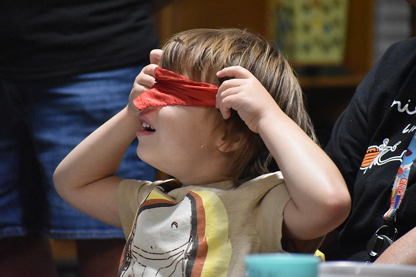 A student plays with a piece of cloth that magically appeared in a Fruitville Elementary classroom.
