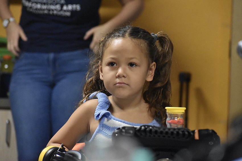 A student watches as Kevin Spencer performs in a Fruitville Elementary classroom.