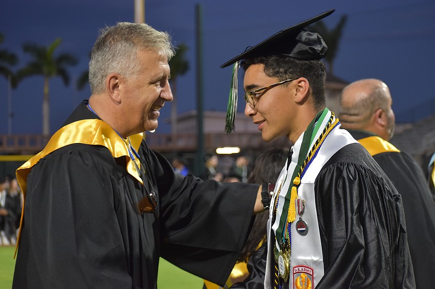 School board member Richard Tatem congratulates LRHS graduate Vicente Rivera who will attend the United States Naval Academy.