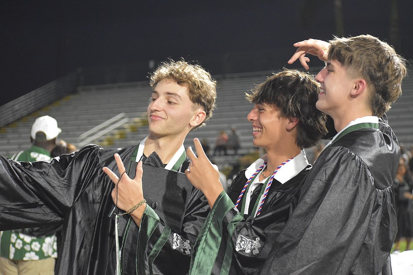 Graduating seniors Kyle Gagnon, Kaden McCoy and Logan Calkins take a selfie at LECOM Park after the commencement ceremony.