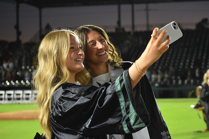 Alexis Eickelmann and Averyy Batey pose for a photo together after receiving their diplomas.
