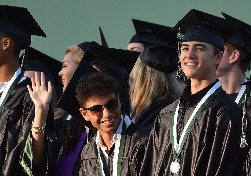 Carmine Nickens and Ledger Newton wait for the commencement ceremony to begin.