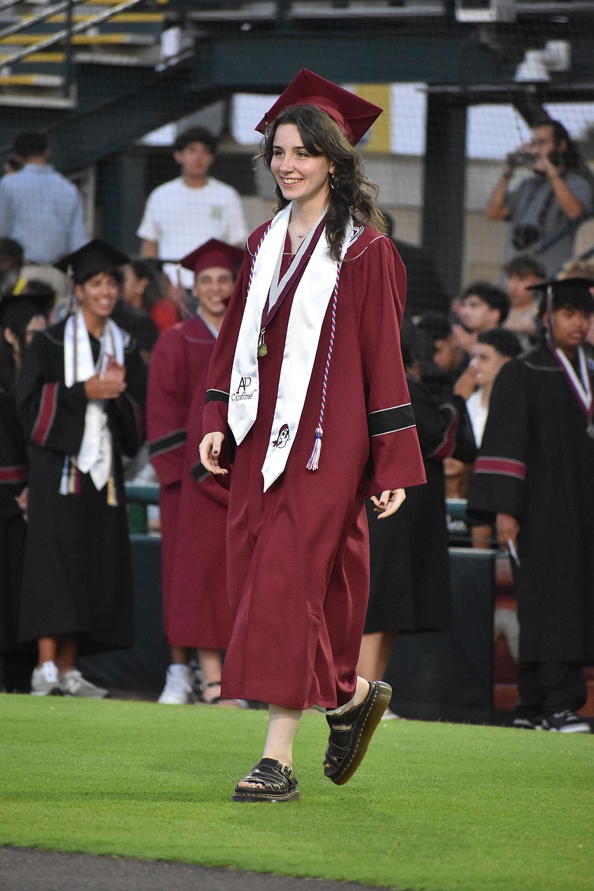 Ayva Culp, a commencement speaker, makes her way toward receiving her diploma.