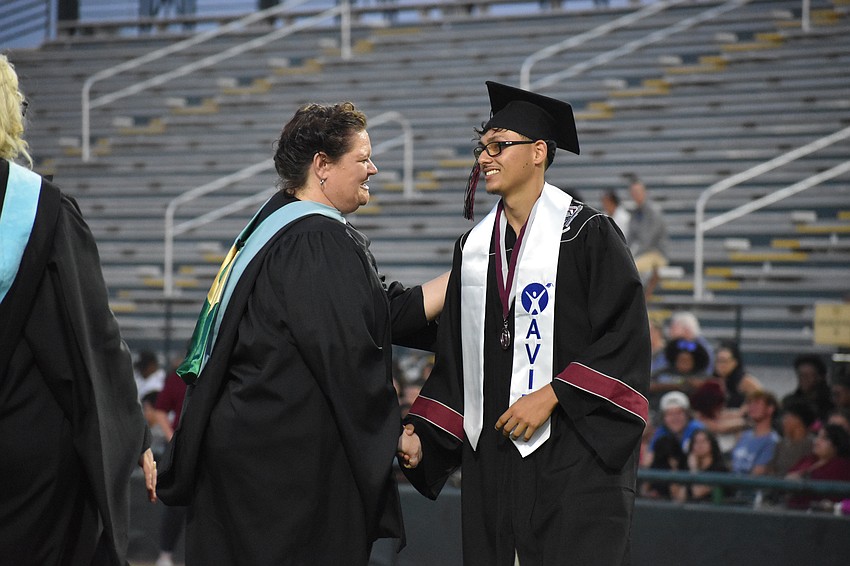 Zaid Ibsais shares a smile and a handshake with assistant principal Rebecca Austerman.