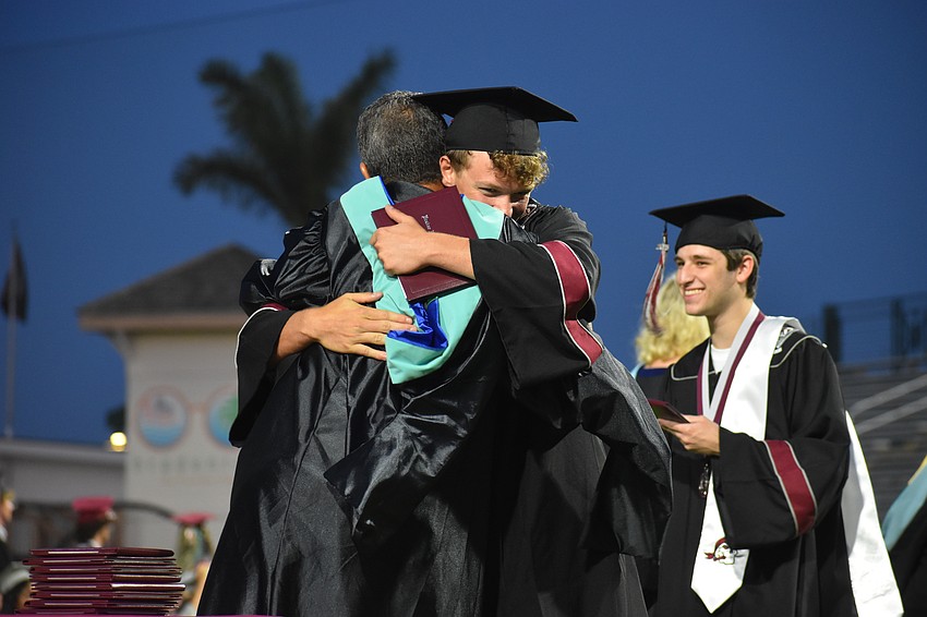 Brayden Sands receives a hug from athletic director Matthew Nesser.