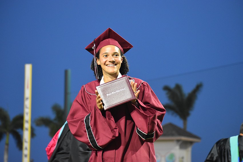 Kaele Smith poses with her diploma right after it is handed to her.