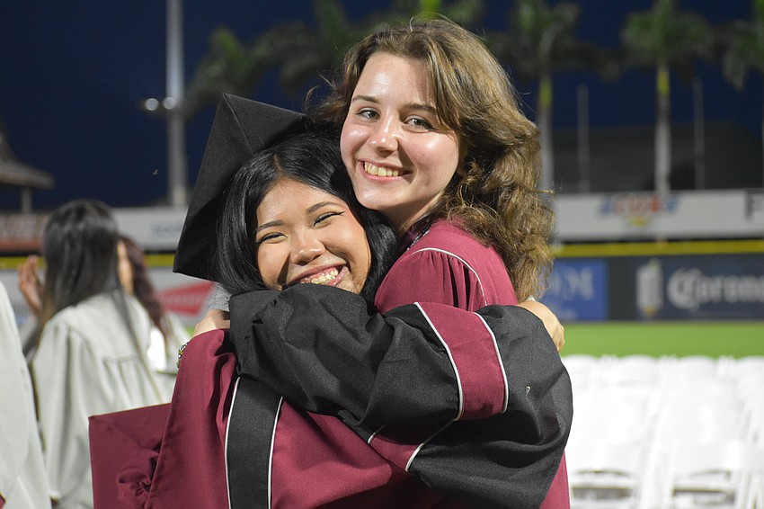 Hien Cao and Ayva Culp share a hug after the commencement ceremony.