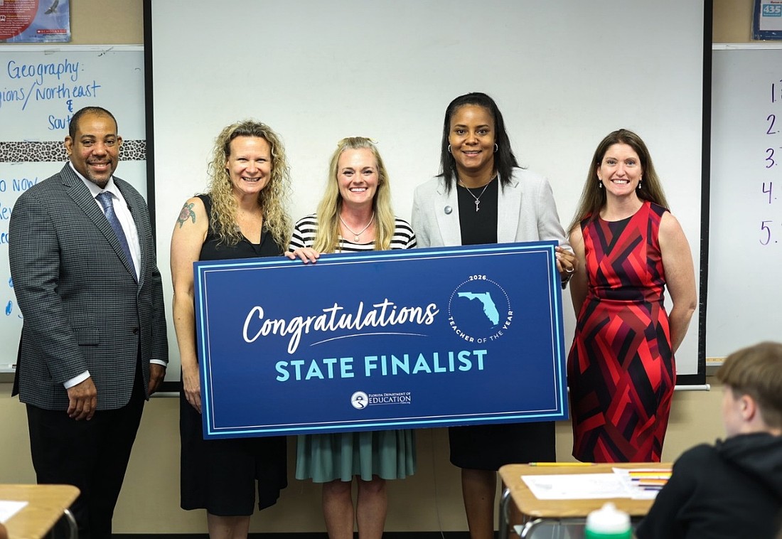 Florida Department of Education Senior Chancellor Paul Burns, Indian Trails Middle School Assistant Principal Katie Hansen, Flagler Schools Superintendent LaShakia Moore and School Board member Lauren Ramirez surprised ITMS teacher Brandy Anderson (center) with the news that she has been named one of five finalists for Florida's Teacher of the Year award. Courtesy photo/Flagler Schools