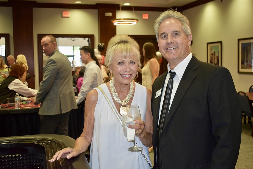 Diane Brune and Mark Clark try their luck at the craps table. Clark is the president of the foundation and Brune was named its 2018 Humanitarian of the Year.