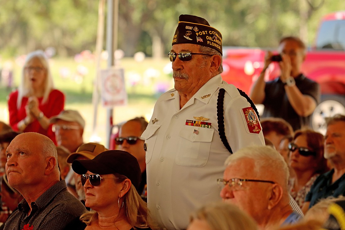 At Woodlawn Memorial Parkâ€™s 74th annual Memorial Day Ceremony, veterans stood as the Orlando Concern Band performed their branchâ€™s song.
