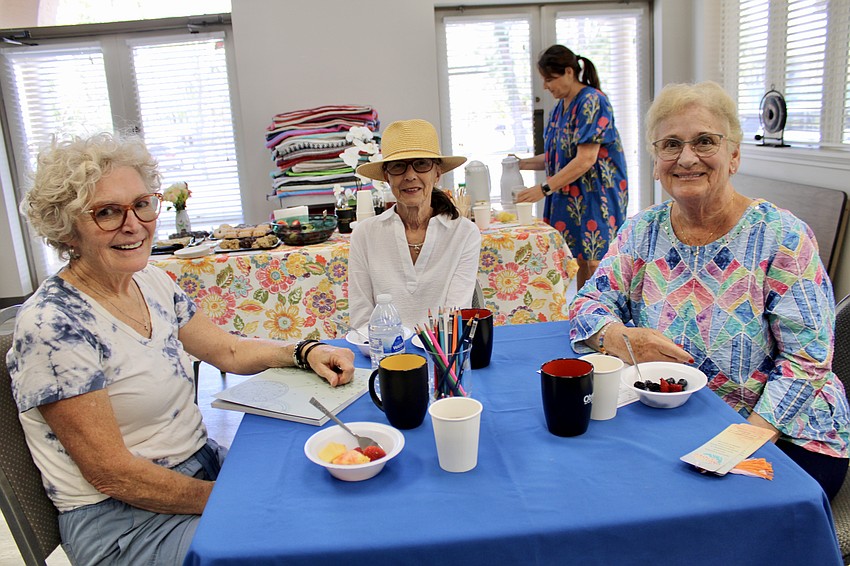 Donna Powell, Maria Ray and Beth Smith enjoy The Paradise Center's first tea party, its first social event since bidding farewell to some seasonal residents.