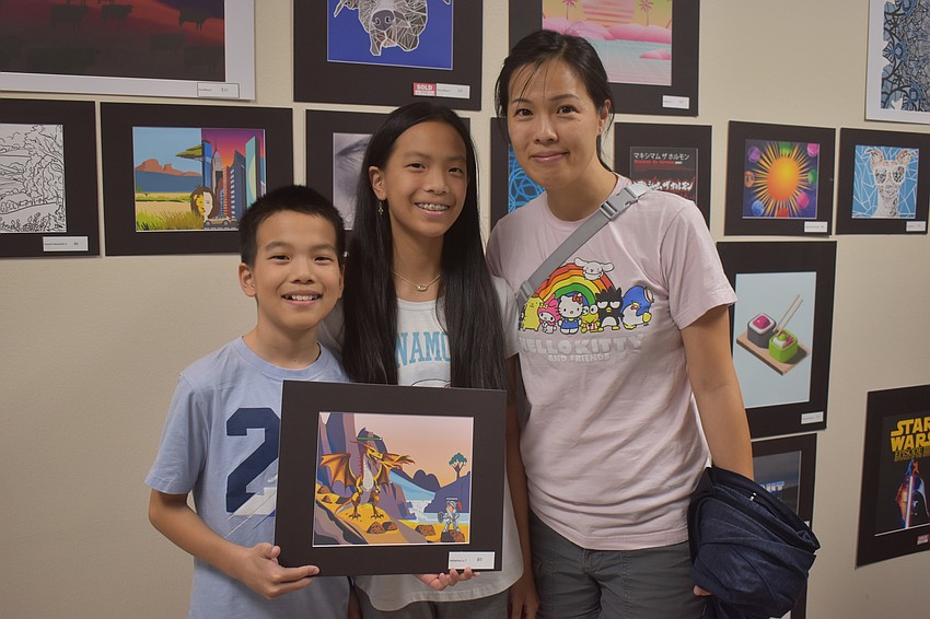 Mona Jain siblings Matthew Lo (6th), Katherine Lo(7th) and their mother Stacy Chen enjoy checking out all the art, but especially the video game inspired piece made by Katherine.
