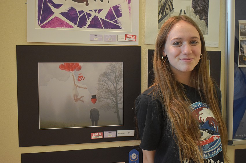 Sally Eckelman, a seventh grade student, created a digital art piece with balloons representing a harsh breakup. The balloon with a top hat represents a man who is disinterested, while the popped balloon is a girl who is floating away as her world shatters.